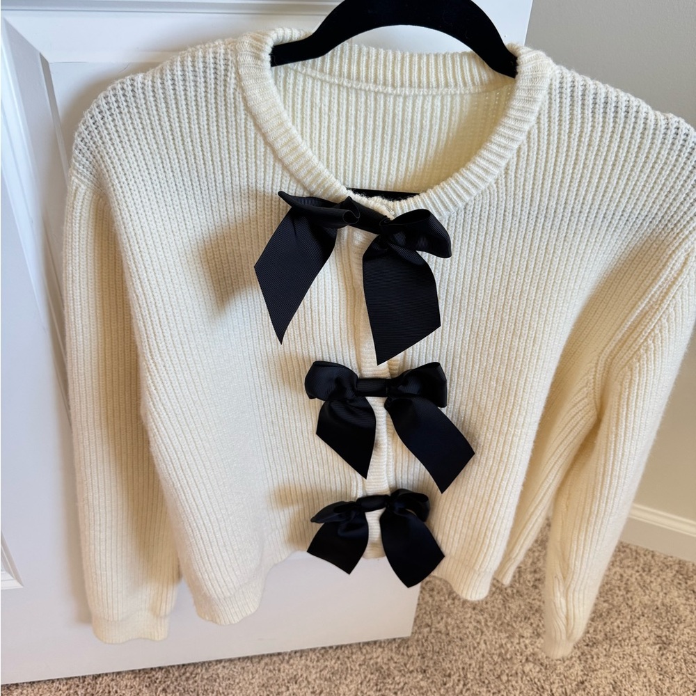 Elegant Cream Sweater with Black Bow Accents